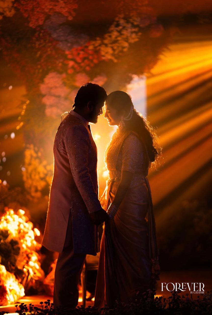 The couple silhouetted against golden light